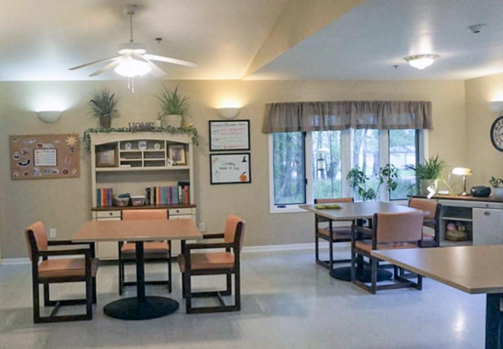 A dining room with a table and chairs.